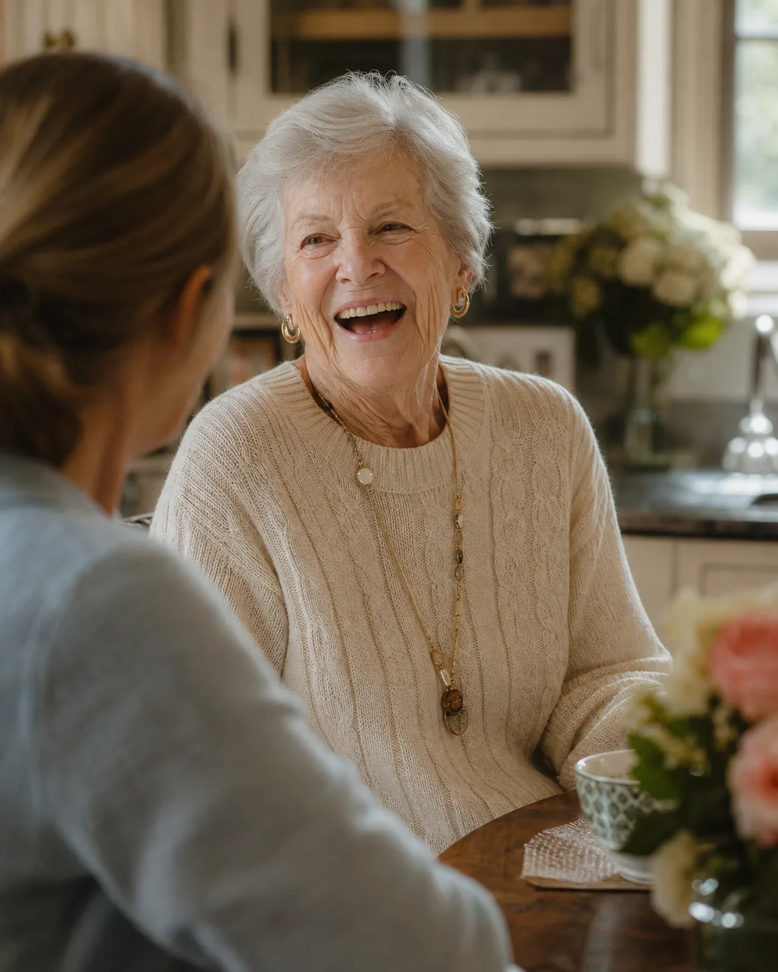 An older woman sharing a conversation with her companion at home